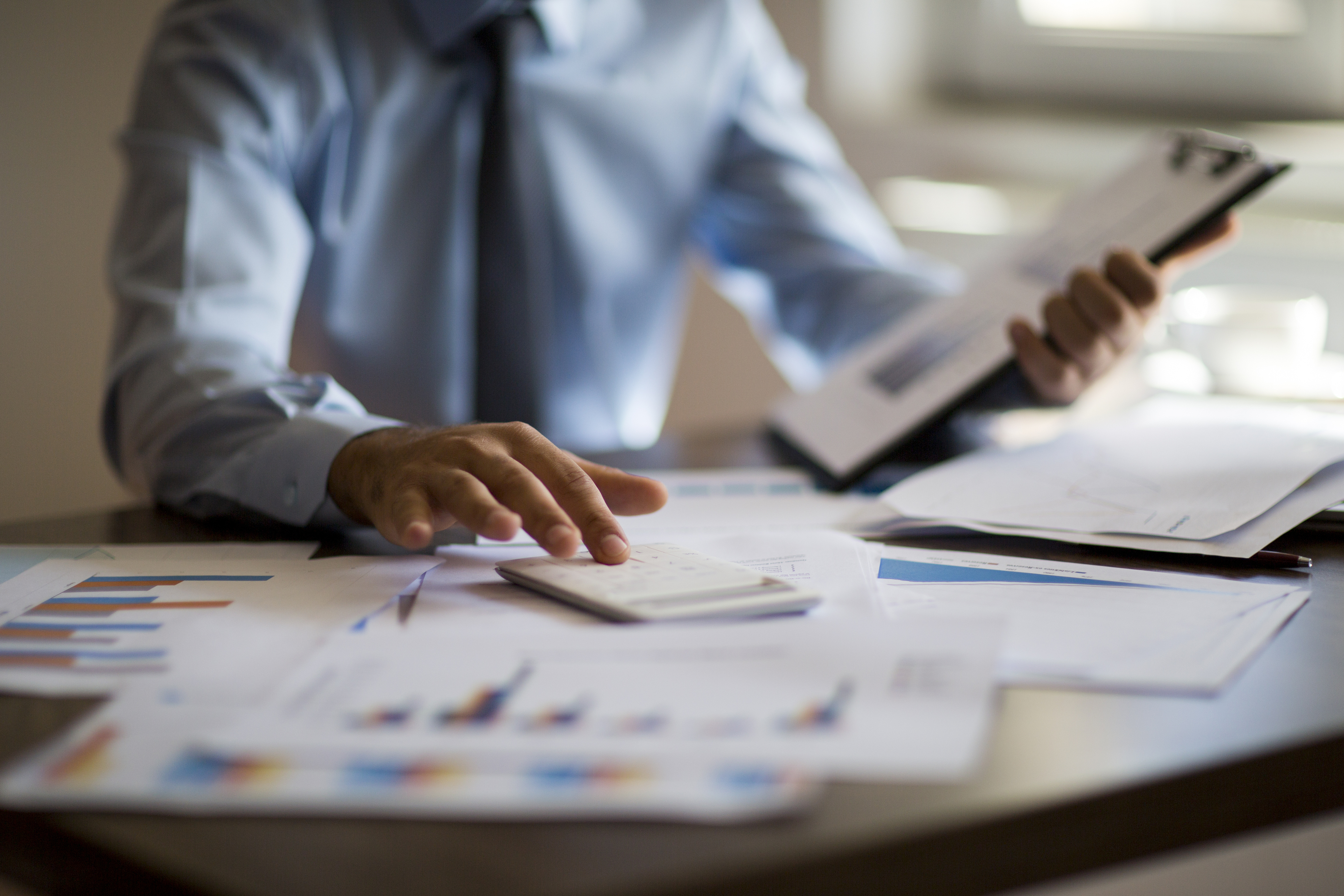 Man in office with calculator