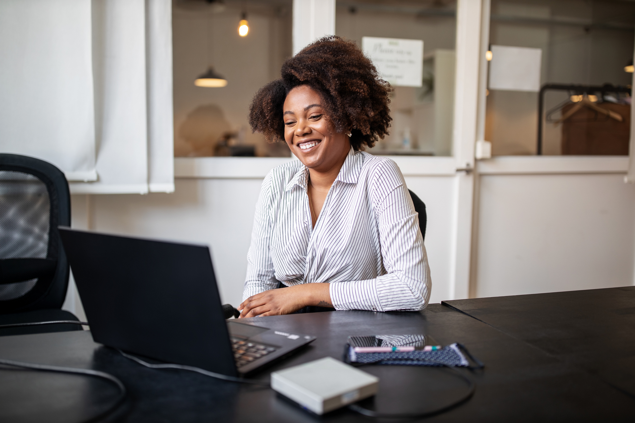 Woman in conference room working on laptop