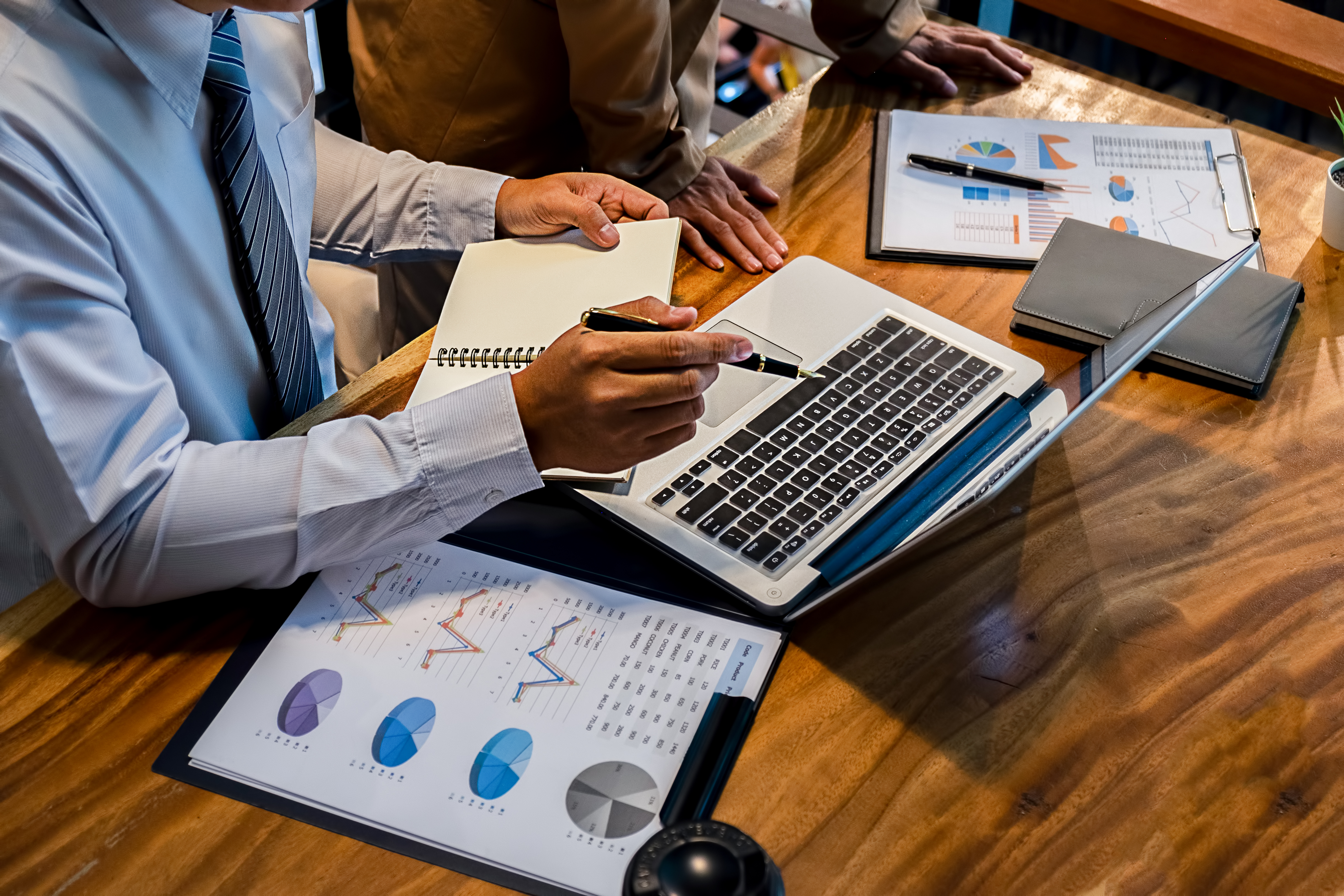 Man sitting at desk reviewing charts