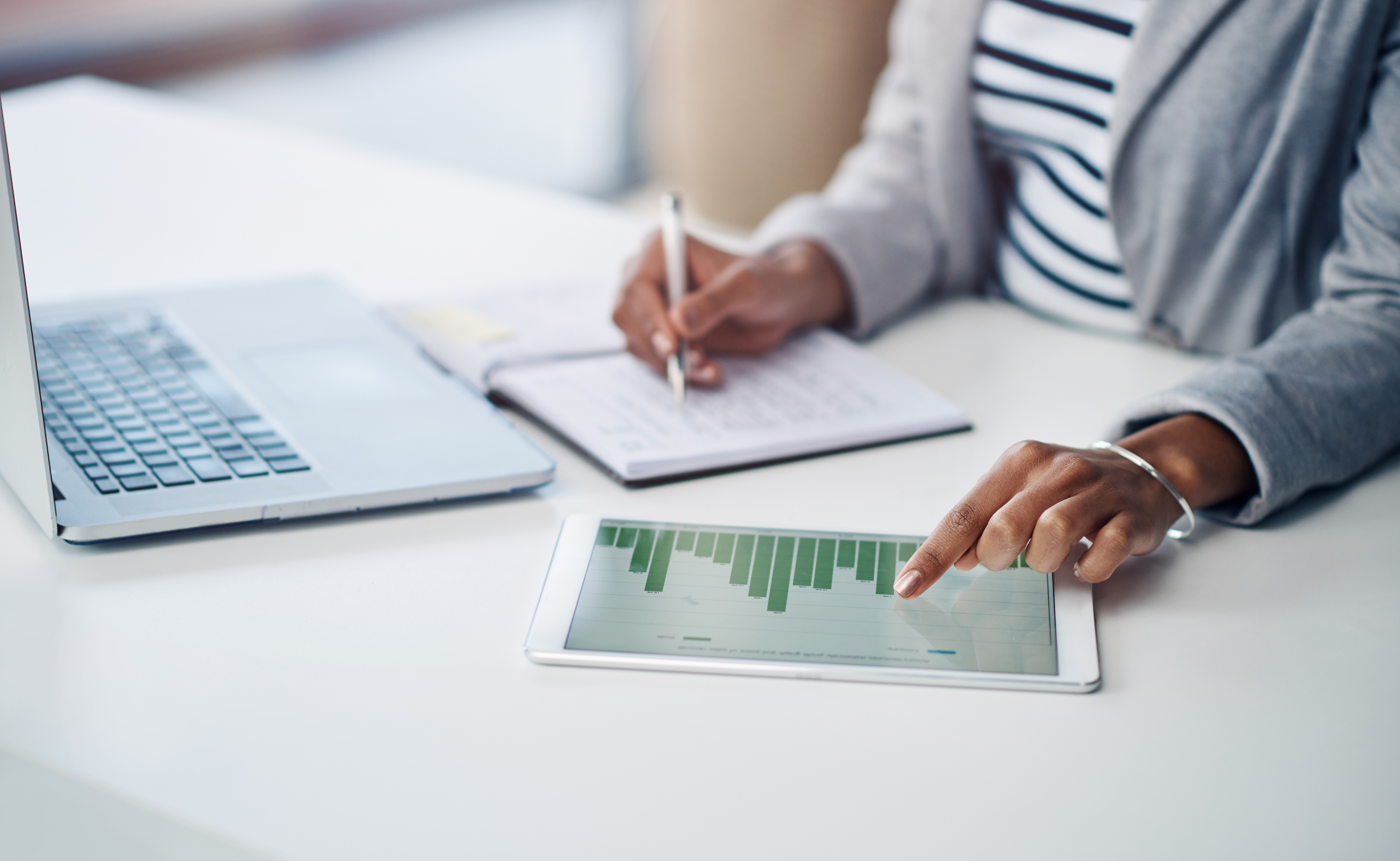 Woman using laptop and tablet at office