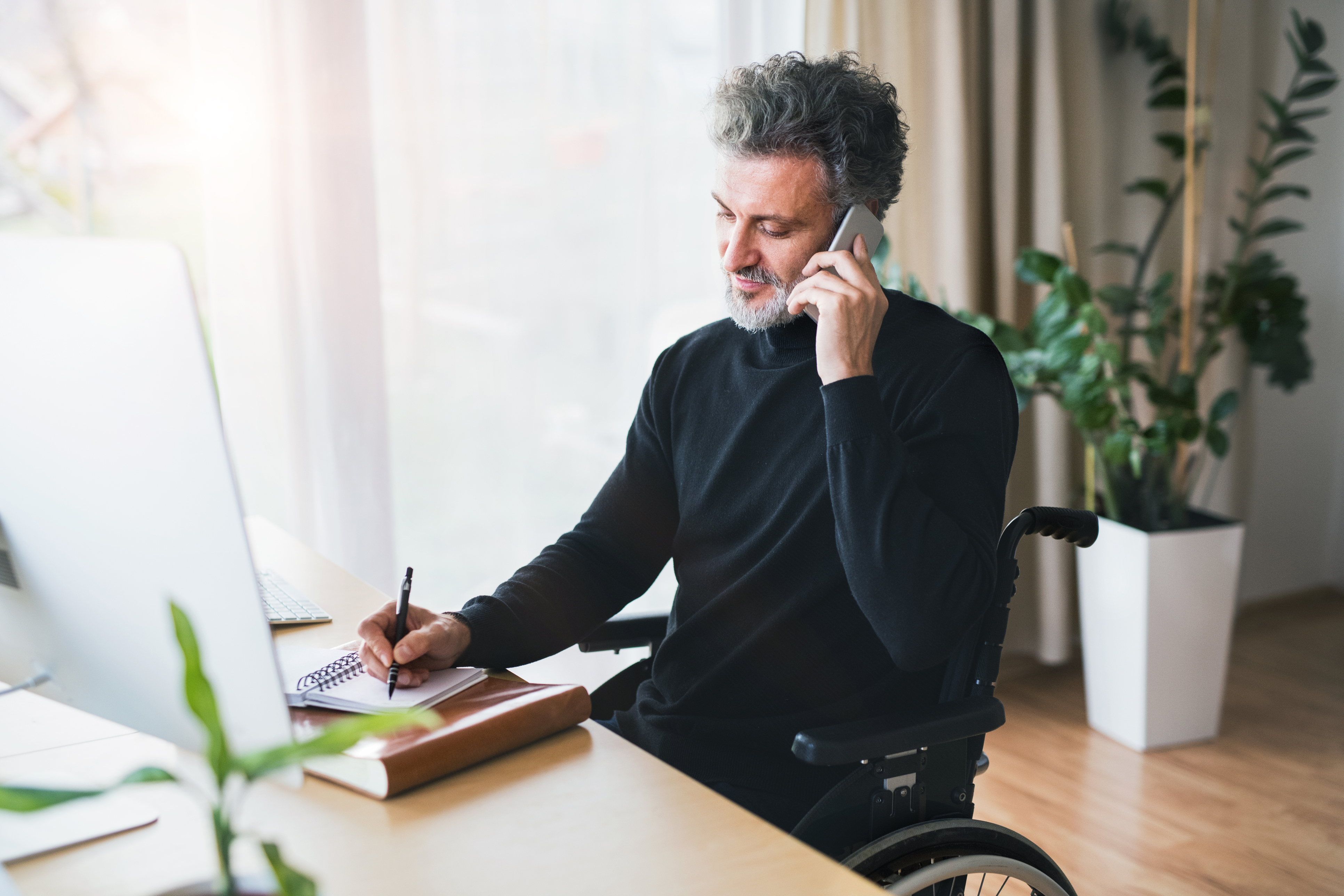 Man talking on phone in office